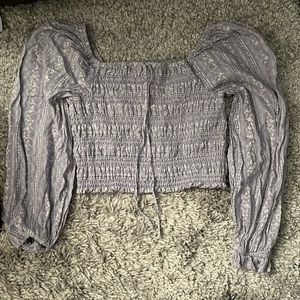 A medium blue shirt with long puffy sleeves